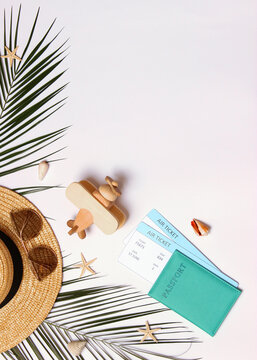 travel accessories and tropical leaves on a colored background top view.. Vertical photo format