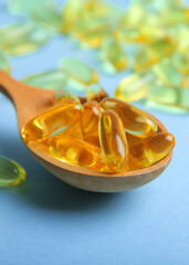Omega 3 capsules on a colored background close-up with place for text.. Vertical photo format 