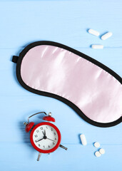 Composition on the theme of insomnia on a colored background. Vertical photo format 
