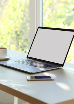 Workplace with modern laptop in the interior of the room. Vertical photo format
