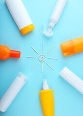 Sunscreens on a colored background top view.. Vertical photo format