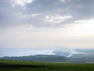 Obraz premium mist creeps up from the sea at st agnes in cornwall on early morning in spring