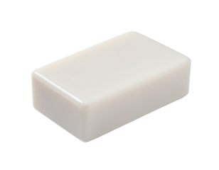 Rectangular, off-white bar of solid soap or similar product