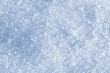 Shiny texture of fresh snow in sunlight, natural winter background in high resolution, abstract cold pattern for design and seasonal projects