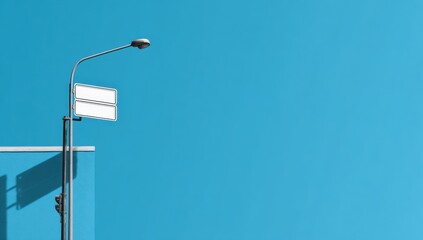 Street lamp and signage against a vibrant blue sky