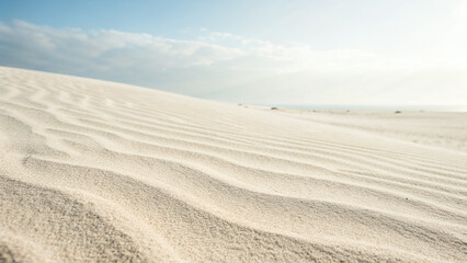 White Sand Dunes with Wavy Patterns under Blue Sky