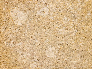 Natural stone texture with yellow and beige shades, surface with irregularities and inclusions for design, background and architectural projects