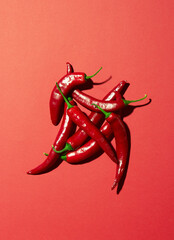 Many red chilli peppers on a red