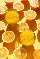 Orange fruit and glass orange juice on a orange back