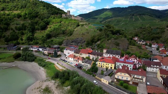 Lower Austria, terraced vineyards, Danube River, historic villages, austrian tourism and landmarks. picturesque village Spitz  and ruined castle Hinterhaus 4k aerial drone video