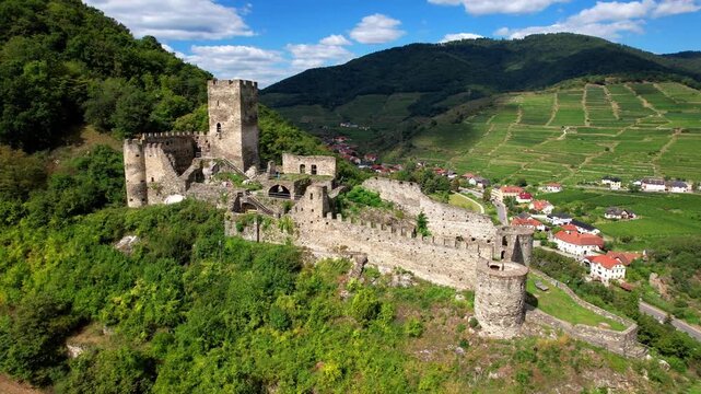 Lower Austria, picturesque village Spitz  and ruined castle Hinterhaus , Danube River, historic villages.  austrian tourism and landmarks. 4k aerial drone video