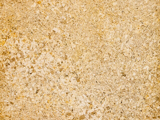 Natural stone texture with yellow and beige shades, surface with irregularities and inclusions for design, background and architectural projects