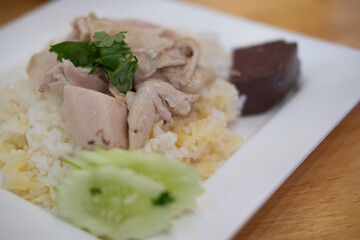 Steamed rice topped with chicken, featuring tender boiled chicken breast and fragrant white rice.