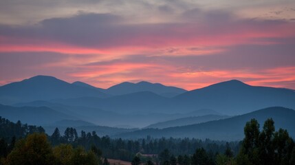 Misty mountain range at sunrise