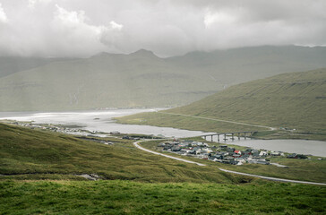 Village and Bridge in Mountain Valley on the Faroe Islands