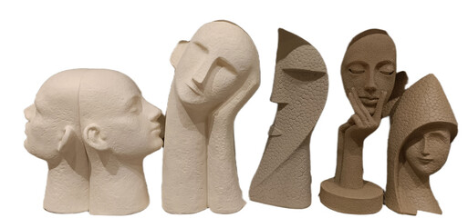 Unique modern sculptures displaying diverse human faces in various shapes and textures arranged artistically