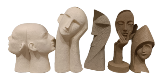 Unique modern sculptures displaying diverse human faces in various shapes and textures arranged artistically