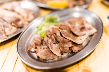 Grilled beef tongue slices,  creating flavorful and appetizing presentation