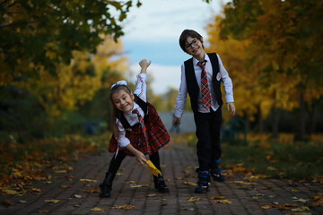 Happy Children in School Uniforms Playing in Autumn Park