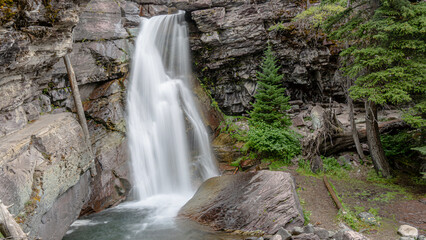 A varied trail where waterfalls highlight the changing beauty of mountains, lakes and forests in Waterton lake national park, Alberta, Canada