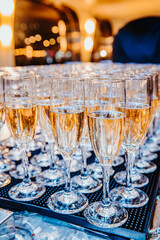 Sparkling glasses ready for celebration. Elegant glasses filled with sparkling beverage are arranged on a tray, ready for a festive gathering or toast.