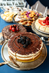 Tasty treats at bakery event. A bakery event showcases colorful cakes and pastries elegantly displayed under bright lighting.