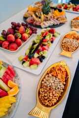 Colorful fruit and snack spread at event. A colorful array of fresh fruits and snacks on a table, making the gathering feel inviting.