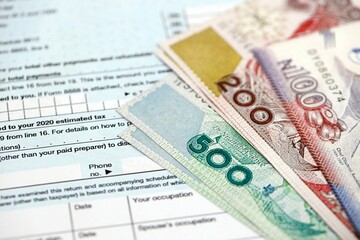Nigerian naira money bills on tax form. Taxation and accounting concept