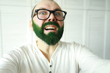 A man with a green beard. St.Patrick 's Day. Irish fan color beard.