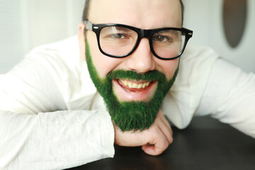 A man with a green beard. St.Patrick 's Day. Irish fan color beard.