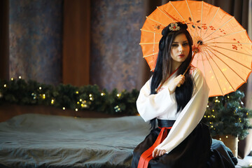 Elegant Woman in Traditional Kimono Holding Orange Parasol