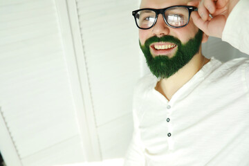 A man with a green beard. St.Patrick 's Day. Irish fan color beard.