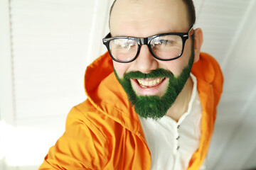 A man with a green beard. St.Patrick 's Day. Irish fan color beard.