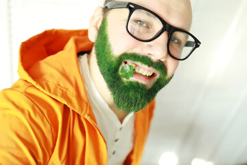A man with a green beard. St.Patrick 's Day. Irish fan color beard.