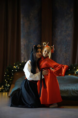 Mother and Daughter in Traditional Asian Attire Celebrating Festive Season