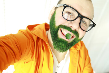 A man with a green beard. St.Patrick 's Day. Irish fan color beard.