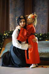 Mother and Daughter in Traditional Asian Attire with Festive Decorations
