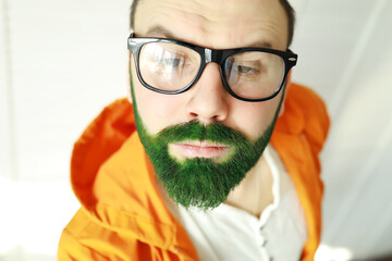 A man with a green beard. St.Patrick 's Day. Irish fan color beard.