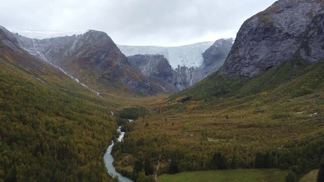 Cinematic drone footage clip of a scenic valley and glacier in Jostedalsbreen National Park, Norway. Landscape orientation. Perfect background video or b-roll.