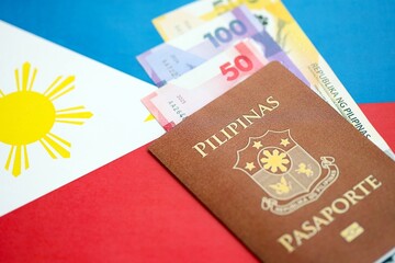 Philippines peso currency money bills and passport lies on flag. The concept of travel and vacation