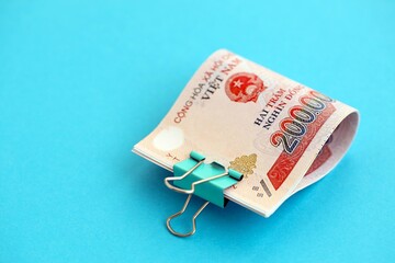 Vietnamese dong money bills in big amount on blue. Finance and banking concept