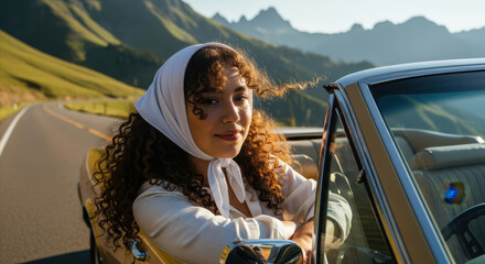woman with curly hair and white headscarf enjoying road trip in convertible along scenic mountain way. adventure and exploration. travel blog
