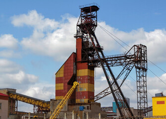 Large industrial facility with towering structure and bright colors under a blue sky