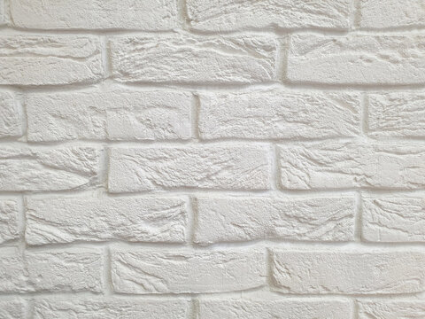 Imitation brickwork with decorative plaster, uneven, rough surface, white color