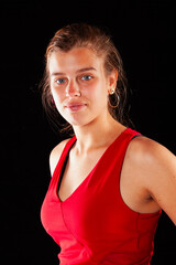 Young and beautiful woman at studio with black backgound