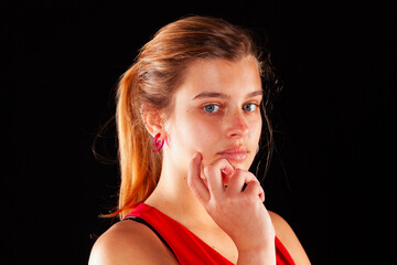 Young and beautiful woman at studio with black backgound