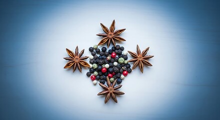 Star anise and peppercorns on blue background