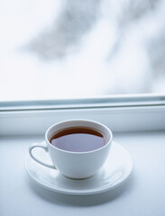 Cup with tea on the background of the winter landscape.