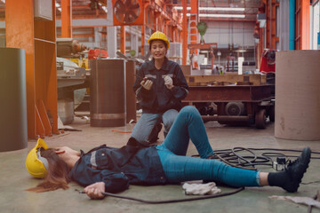 A female employee is helping her friend who was electrocuted in a metal cheese factory.