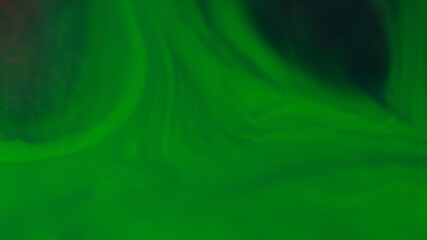 Paint background. Color water. Defocused green chemical fluid liquid shiny smooth emulsion floating on abstract wet dark black art.